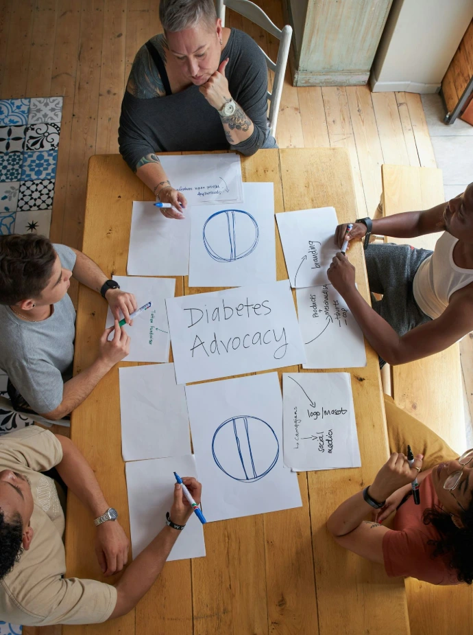 People collaboratively work on diabetes advocacy plans.